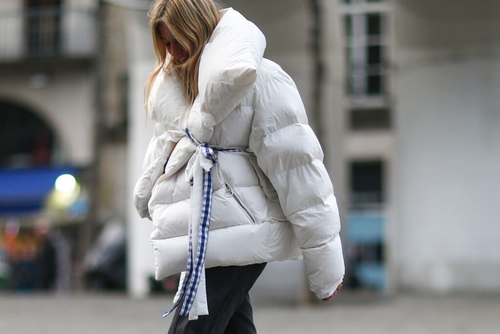 Une femme qui porte un manteau de la marque Monki